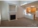 Inviting living room featuring a fireplace and a seamless transition to the adjacent kitchen at 8838 Wandering Creek Way, Charlotte, NC 28227