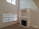 Sunlit living room highlighting a fireplace and large window with ample natural light at 8838 Wandering Creek Way, Charlotte, NC 28227