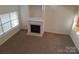 Living room with fireplace and large window at 8838 Wandering Creek Way, Charlotte, NC 28227