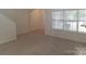 Open living room space with stairs and doorway to another room at 8838 Wandering Creek Way, Charlotte, NC 28227