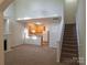 Bright, open living room with fireplace, stairs, and seamless flow to kitchen area at 8838 Wandering Creek Way, Charlotte, NC 28227