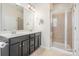 Modern bathroom featuring a double sink vanity with granite countertops and a glass-enclosed shower at 9001 Lanark Ln, Fort Mill, SC 29707