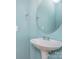 Powder room featuring a pedestal sink, oval mirror, and light blue painted walls at 9001 Lanark Ln, Fort Mill, SC 29707