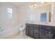This bathroom features a double sink vanity with modern fixtures, a separate tub and a toilet at 9001 Lanark Ln, Fort Mill, SC 29707