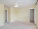 Bedroom with carpet, ceiling fan, and ample closet space, perfect for storage at 9001 Lanark Ln, Fort Mill, SC 29707