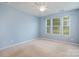 Spacious bedroom with natural light from large windows and plush carpet at 9001 Lanark Ln, Fort Mill, SC 29707