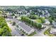 Wide aerial view of the lovely community with townhomes, lush green spaces, and mature trees at 9001 Lanark Ln, Fort Mill, SC 29707
