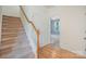 Inviting entryway with hardwood floors, carpeted stairs, and access to the upper level at 9001 Lanark Ln, Fort Mill, SC 29707