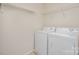 Bright laundry room features a full size washer and dryer with wire shelving above at 9001 Lanark Ln, Fort Mill, SC 29707