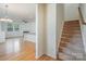 Open-concept living area with hardwood floors, staircase, and views of the fireplace at 9001 Lanark Ln, Fort Mill, SC 29707