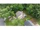 Aerial view of home featuring mature trees, brick chimney, and green lawn at 906 Wishing Well Ln, Charlotte, NC 28270