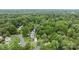 Aerial view showcases a home nestled among lush trees in a residential neighborhood at 906 Wishing Well Ln, Charlotte, NC 28270