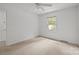 Cozy bedroom with neutral carpet, a ceiling fan, and a bright window at 906 Wishing Well Ln, Charlotte, NC 28270