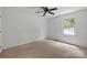 Bright bedroom with carpet flooring, neutral walls, and a ceiling fan at 906 Wishing Well Ln, Charlotte, NC 28270