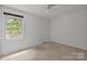 Bedroom featuring carpeted floor, white trim, and a ceiling fan at 906 Wishing Well Ln, Charlotte, NC 28270