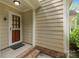 Inviting front porch showcasing brick steps and a charming screen door at 906 Wishing Well Ln, Charlotte, NC 28270