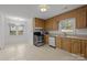 Functional kitchen with wooden cabinets and tile flooring at 906 Wishing Well Ln, Charlotte, NC 28270