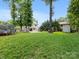 Spacious backyard with green grass, trampoline, swing set, and playhouse at 9908 Park Springs Ct, Charlotte, NC 28210