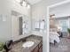 Stylish bathroom with granite countertop vanity, modern fixtures, and a view into the relaxing bedroom at 9908 Park Springs Ct, Charlotte, NC 28210