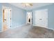 Bright bedroom with carpeted floors and two white doors providing ample closet space at 9908 Park Springs Ct, Charlotte, NC 28210