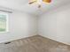 Bedroom with carpeted floors, light walls, natural light, and ceiling fan at 9908 Park Springs Ct, Charlotte, NC 28210