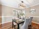 This dining room features hardwood floors, modern lighting, and open access to other parts of the house at 9908 Park Springs Ct, Charlotte, NC 28210