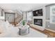 Bright living room with a painted brick fireplace, a flat screen TV, and hardwood floors at 9908 Park Springs Ct, Charlotte, NC 28210