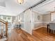 Open-concept living space with hardwood floors, stairs, and a sliding barn door leading to the dining area at 9908 Park Springs Ct, Charlotte, NC 28210