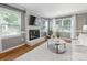 The living room features a brick fireplace, large windows with blinds and curtains, and a neutral color palette at 9908 Park Springs Ct, Charlotte, NC 28210