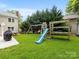 Playground with a swing set, slide, and climbing structure in a backyard at 9908 Park Springs Ct, Charlotte, NC 28210