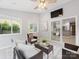 Cozy sunroom with comfortable seating, great lighting, and sliding glass doors to the yard at 9908 Park Springs Ct, Charlotte, NC 28210