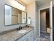 Bathroom features a granite countertop, undermount sink, and a stylish, modern mirror for a sleek design at 113 Foxfield Ln, Matthews, NC 28105
