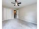 Bedroom with gray carpet, ceiling fan, a double door closet and hallway access at 113 Foxfield Ln, Matthews, NC 28105