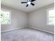 Bright bedroom with two large windows and a ceiling fan at 113 Foxfield Ln, Matthews, NC 28105