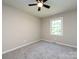 Neutral bedroom with new carpet, fan, and window offering plenty of natural light at 113 Foxfield Ln, Matthews, NC 28105