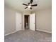 Bedroom with new carpet, ceiling fan, two doors, and trim at 113 Foxfield Ln, Matthews, NC 28105