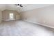 Spacious bonus room with neutral paint, plush carpeting, and ample natural light from the large window at 113 Foxfield Ln, Matthews, NC 28105