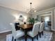 Cozy dining room with elegant decor, modern lighting, and a view into the living room at 113 Foxfield Ln, Matthews, NC 28105