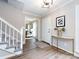 Inviting foyer with wood floors, white staircase, and stylish decor at 113 Foxfield Ln, Matthews, NC 28105