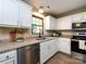 Updated kitchen featuring stainless steel appliances, granite countertops, and ample natural light at 113 Foxfield Ln, Matthews, NC 28105
