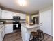 Spacious kitchen with stainless steel appliances, granite countertops, and a cozy breakfast bar at 113 Foxfield Ln, Matthews, NC 28105