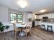 Open kitchen and dining area with bright lighting, stainless appliances, and breakfast nook at 113 Foxfield Ln, Matthews, NC 28105