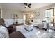 Bright living room with neutral paint, ceiling fan, and large window at 113 Foxfield Ln, Matthews, NC 28105