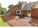 Cozy patio with outdoor seating next to a two-story brick home at 113 Foxfield Ln, Matthews, NC 28105