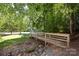 Wood bridge over small creek in a wooded common area at 113 Foxfield Ln, Matthews, NC 28105