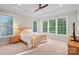 Bedroom featuring a tray ceiling, large windows, carpet flooring, and a ceiling fan at 114 Canoe Pole Ln, Mooresville, NC 28117
