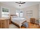 Charming bedroom featuring a ceiling fan and natural light from three windows at 114 Canoe Pole Ln, Mooresville, NC 28117