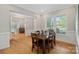 Well-lit dining room featuring hardwood floors, classic trim, and a wooden table with seating for six at 114 Canoe Pole Ln, Mooresville, NC 28117