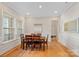 Bright dining area with hardwood floors, wainscoting, and a wooden table perfect for Gathering meals at 114 Canoe Pole Ln, Mooresville, NC 28117