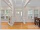 Bright entryway with hardwood floors, white trim, and ample natural light streaming through large windows at 114 Canoe Pole Ln, Mooresville, NC 28117
